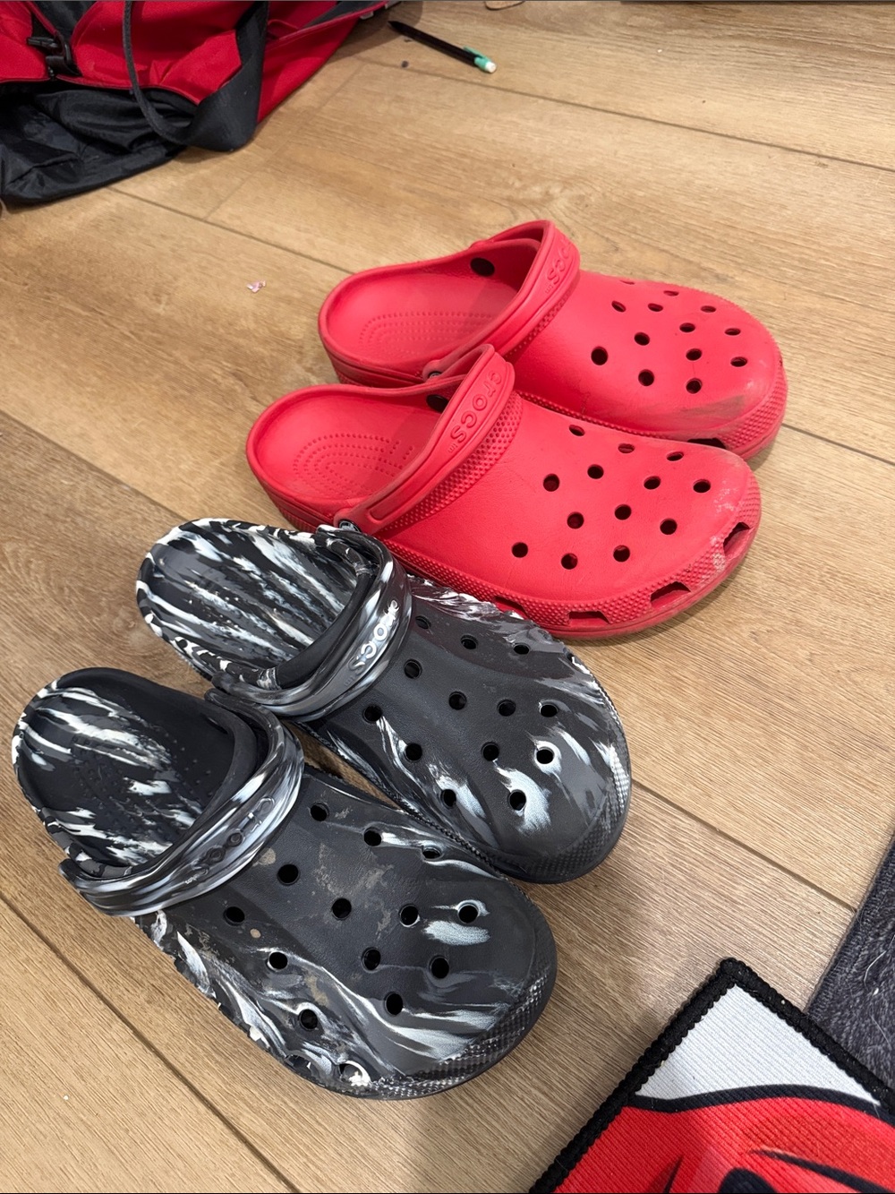 CROCS Slip-On Clogs in Solid Red and Black/White Marble